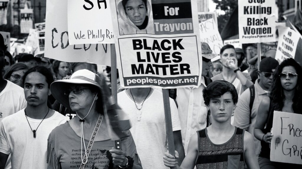 Social Issues and Activism: Protesters holding signs advocating for racial equality.