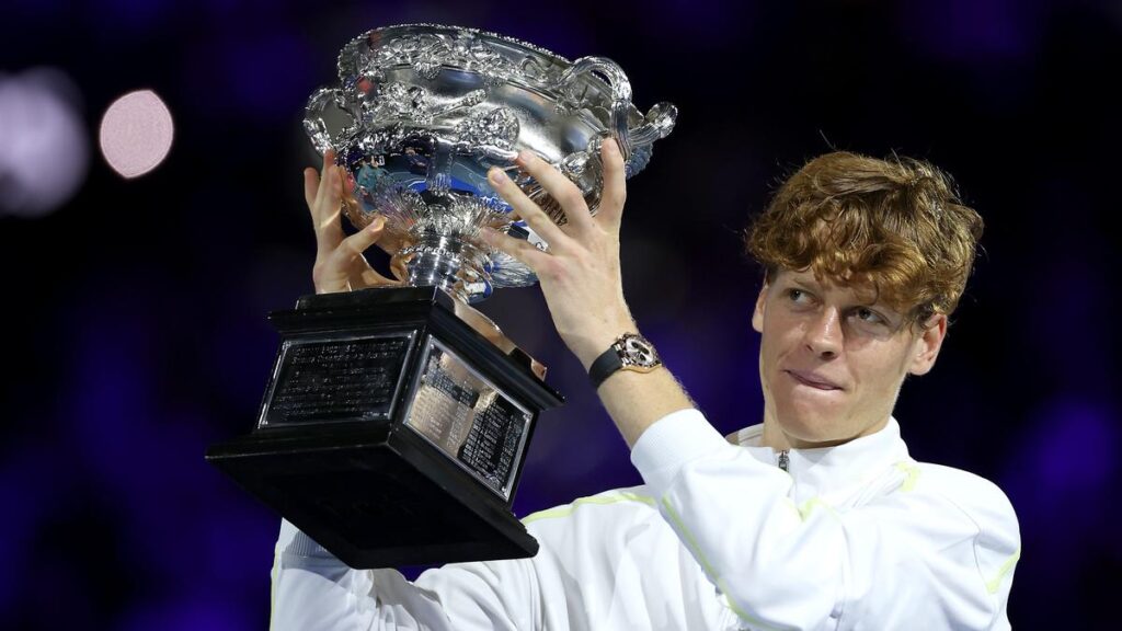  Jannik Sinner holding the Australian Open trophy after his victory.